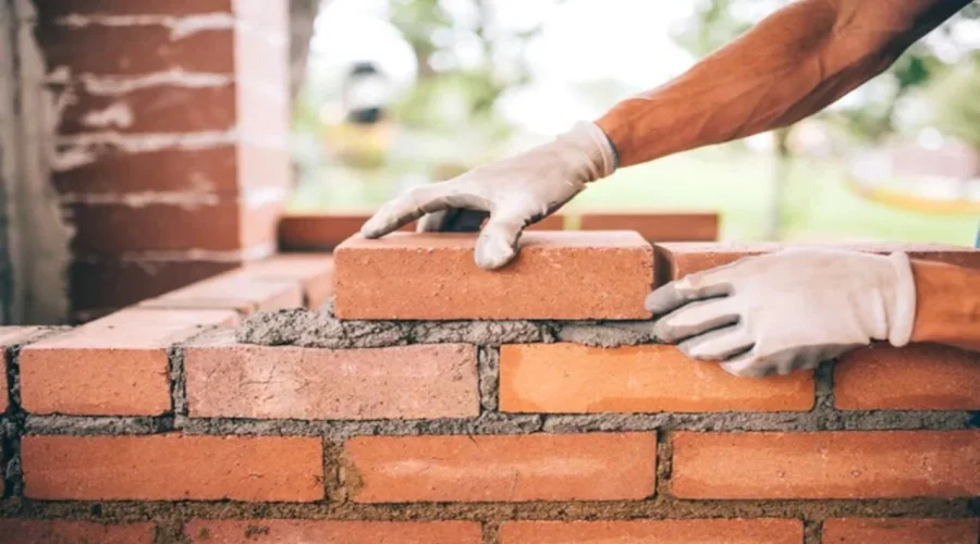 depositphotos_118621020-stock-photo-professional-construction-worker-laying-bricks