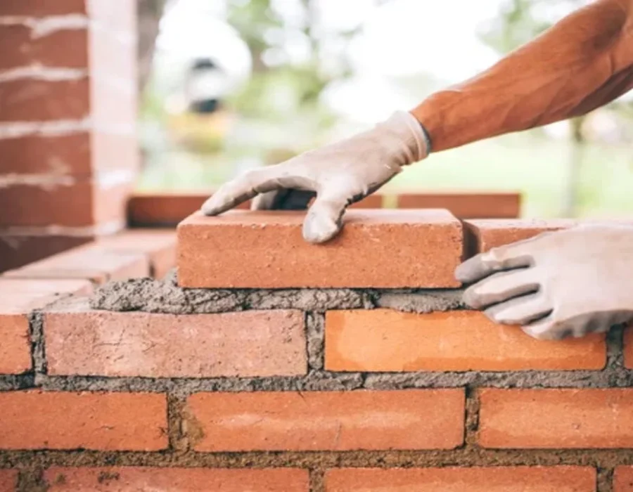 depositphotos_118621020-stock-photo-professional-construction-worker-laying-bricks